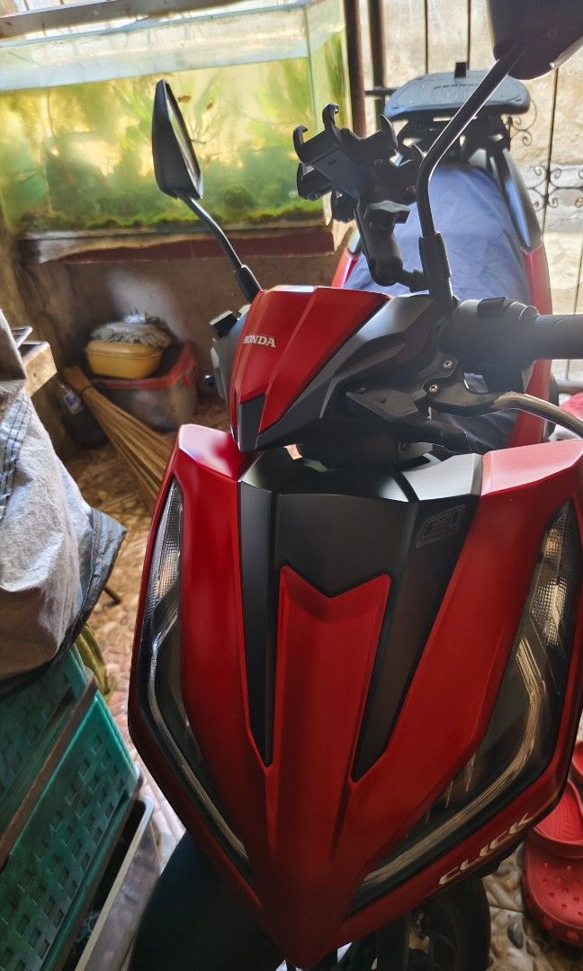 Honda Click Motorcycle 2024 Aquire (Category: Motorbikes for Sale) located in Taguig. Submitted by Jay___R (Listing ID 1435173589, Image 2). Description: Red and black Honda Click motorcycle with a top box. Features a comfortable seat and a sleek design. Includes side mirrors and a front headlight. Perfect for daily commutes or weekend rides..