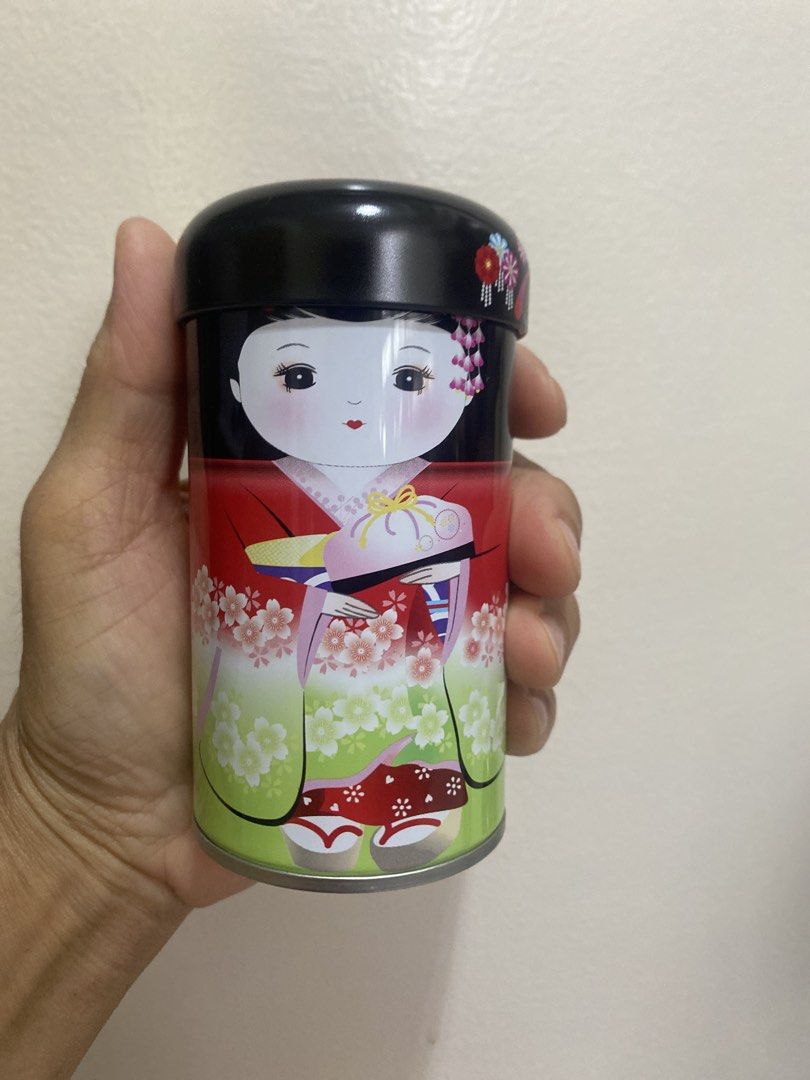 Japanese Doll Storage Containers Set (Category: Storage Boxes & Baskets) located in Marikina City. Submitted by myprelovedcollectibles (Listing ID 1435946079, Image 3). Description: - Set of 5 decorative storage containers. - Features Japanese doll designs. - Each container has a unique color and doll illustration. - Cylindrical metal containers with lids. - Presented in a pink box..