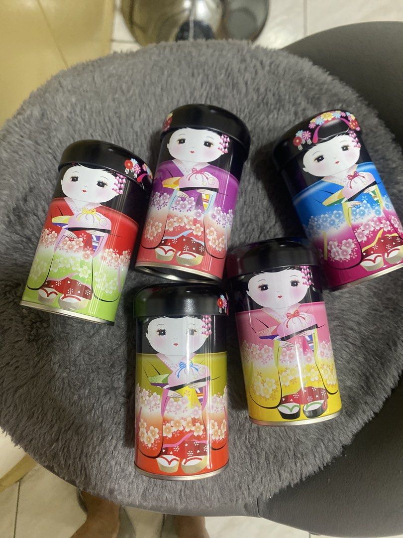 Japanese Doll Storage Containers Set (Category: Storage Boxes & Baskets) located in Marikina City. Submitted by myprelovedcollectibles (Listing ID 1435946079, Image 2). Description: - Set of 5 decorative storage containers. - Features Japanese doll designs. - Each container has a unique color and doll illustration. - Cylindrical metal containers with lids. - Presented in a pink box..