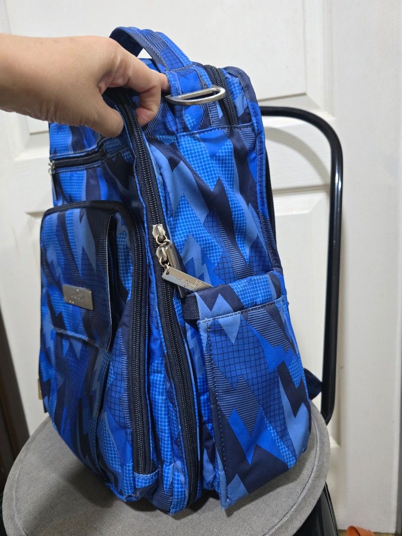 JuJuBe BRB Backpack (Category: Maternity Care) located in Pasig City. Submitted by litinpink (Listing ID 1435917343, Image 2). Description: - JuJuBe backpack with a striking blue geometric design. - Includes a front pocket and a spacious main compartment. - Comfortable padded straps and breathable mesh back panel. - Top handle for easy carrying. - Durable construction for long-lasting use..