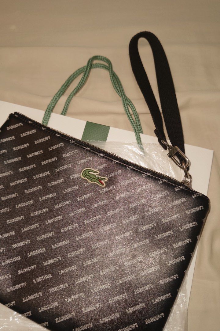 Lacoste Clutch Bag (Category: Luxury Bags & Wallets) located in Muntinlupa City. Submitted by goldlevel (Listing ID 1436074716, Image 2). Description: Monogram Lacoste Clutch Bag Blue Lining Inside.