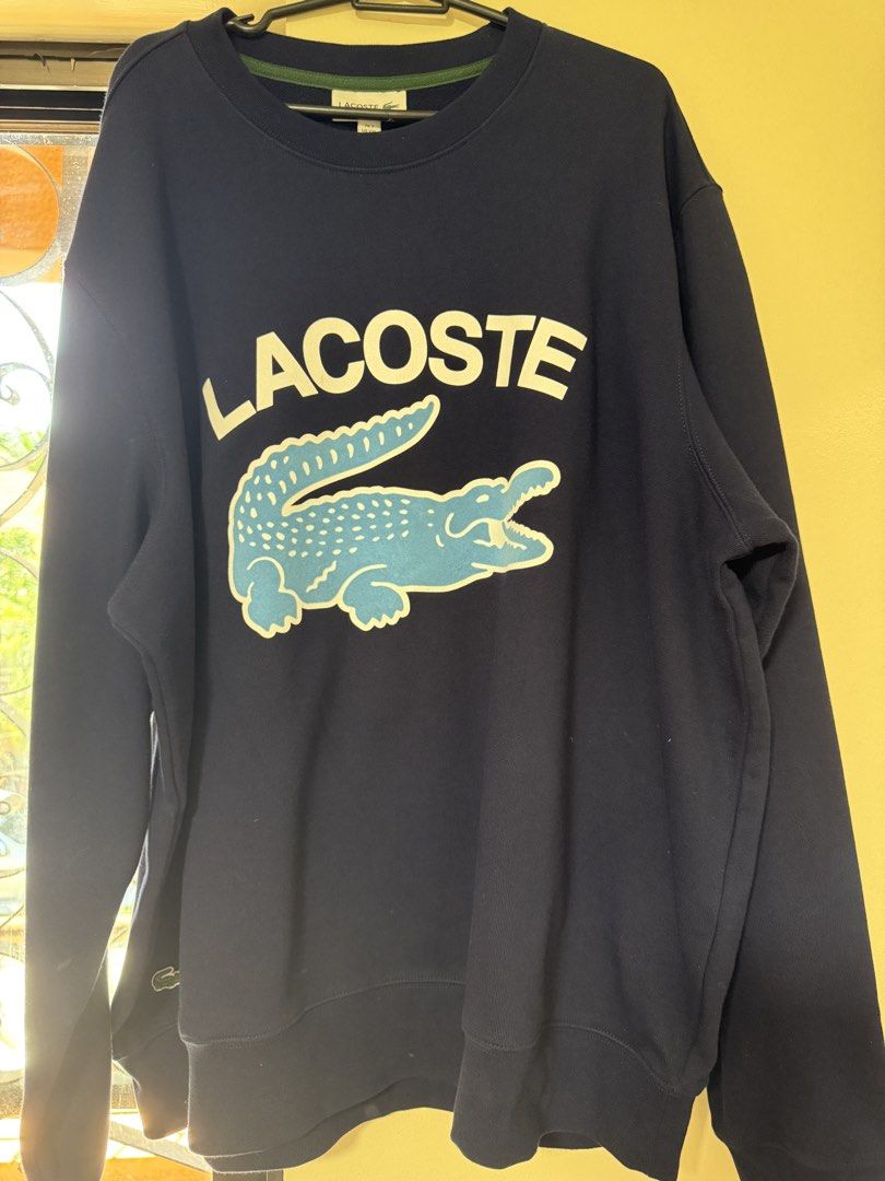 Lacoste Crew Neck Sweatshirt (Category: Coats, Jackets and Outerwear) located in Manila. Submitted by niknikdomdom (Listing ID 1436064314, Image 1). Description: - Navy blue Lacoste sweatshirt - Features the iconic white crocodile logo - Classic crew neck design - Comfortable long sleeves - Made from a soft, cozy material - Ideal for everyday casual wear.