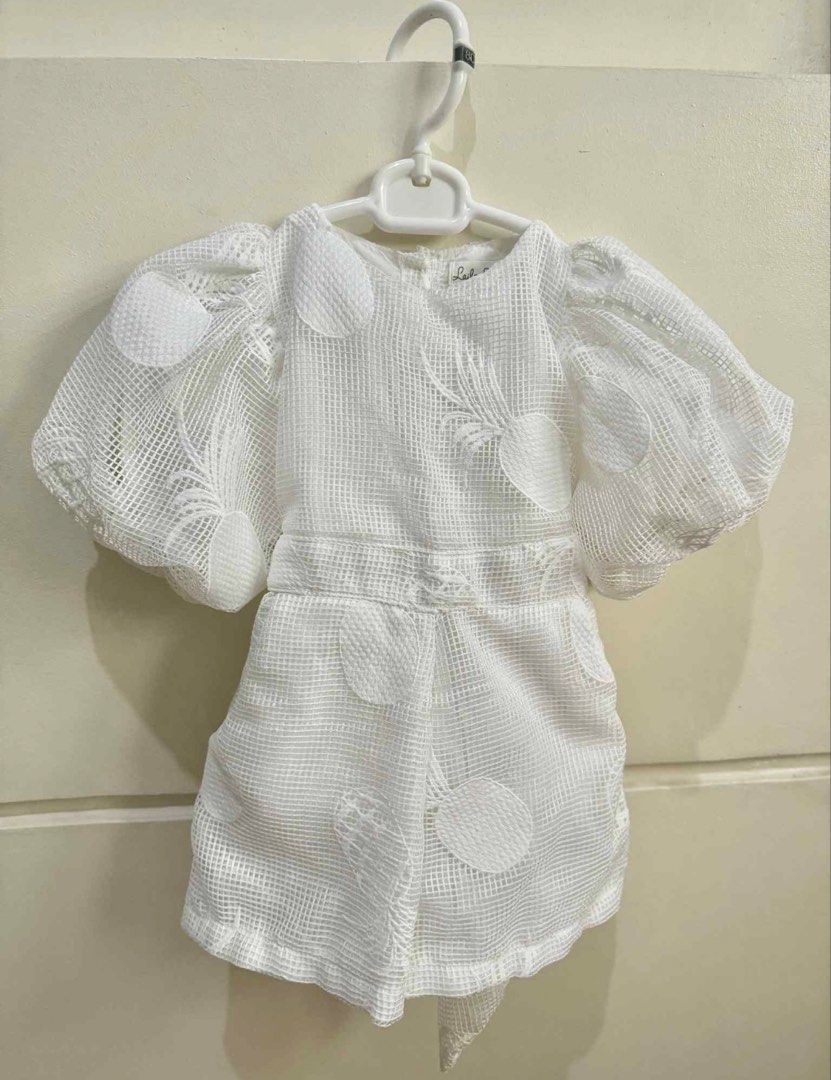 Laila & Lyra Sandrine Twinning (Category: Babies & Kids Fashion) located in San Juan City. Submitted by lovedbymaiagia (Listing ID 1435997103, Image 3). Description: Laila & Lyra Sandrine Matching mother-daughter dress set White, textured fabric with pineapple embroidery Adult dress: V-neck, tiered skirt, medium Child's romper: puff sleeves, tie detail at back, size 3 .