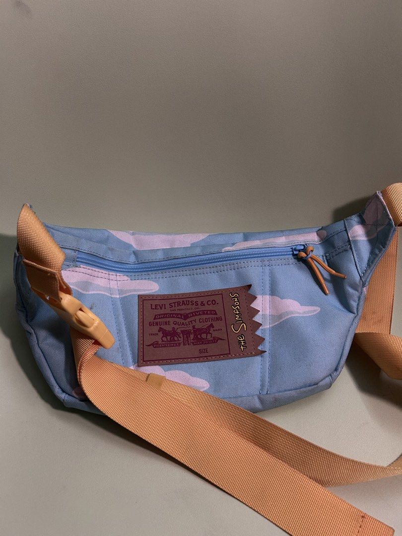 Levi's x The Simpsons Fanny Pack (Category: Cross-body Bags) located in Paranaque City. Submitted by username300 (Listing ID 1435975466, Image 2). Description: - Cloud pattern fanny pack - Levi's x The Simpsons collaboration patch - Zippered main compartment - Adjustable strap - Light blue base color - Yellow strap - Stylish and functional.