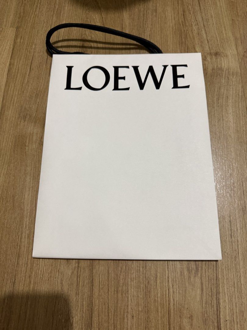 Loewe Shopping Bag (Category: Craft Supplies & Tools) located in Valenzuela. Submitted by minami34 (Listing ID 1436029994, Image 1). Description: - Authentic Loewe Shopping Bag - Classic white color - Features the iconic LOEWE logo (Embossed) - Ideal for gifting or personal use Dimensions: (L- 30.9cm x W- 23.9cm x D - 8cm) Reason for selling: Declutter Note: Shipping Fee (SF) still not included. Mode of Payment: Bank Transfer (BDO/BPI) or GCash D