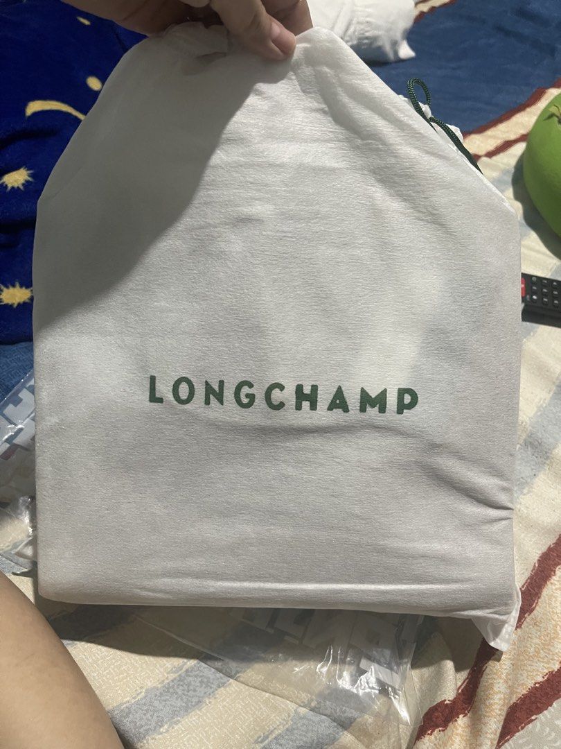 Longchamp Roseau Essential Khaki Handbag (Category: Luxury Bags & Wallets) located in Manila. Submitted by tineferna08917 (Listing ID 1435923930, Image 3). Description: - Authentic Longchamp Roseau Essential handbag - Color: Khaki - Features: - Top handle - Detachable shoulder strap - Flap closure with gold-tone snap - Includes: Dust bag and tags - Spacious interior - Perfect for everyday use.