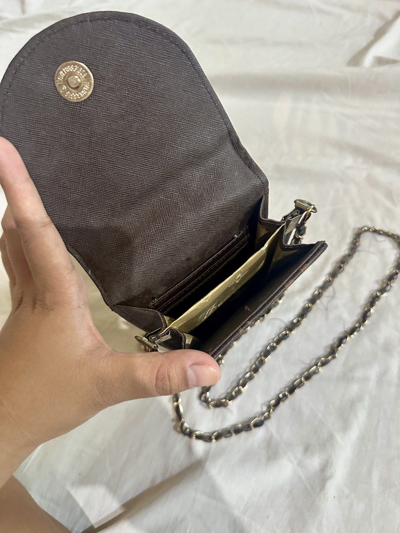 Louis Vuitton Monogram Phone Bag with Chain (Category: Luxury Bags & Wallets) located in Talavera. Submitted by elledepartment (Listing ID 1435972322, Image 2). Description: Louis Vuitton Monogram Phone Bag. Features flap closure, gold LV logo, chain strap, and card slots. Brown color. Duplicate only Issue: Sling (Detachable) Free only, just buy at least one on my listings.