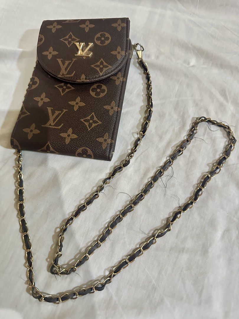 Louis Vuitton Monogram Phone Bag with Chain (Category: Luxury Bags & Wallets) located in Talavera. Submitted by elledepartment (Listing ID 1435972322, Image 1). Description: Louis Vuitton Monogram Phone Bag. Features flap closure, gold LV logo, chain strap, and card slots. Brown color. Duplicate only Issue: Sling (Detachable) Free only, just buy at least one on my listings.