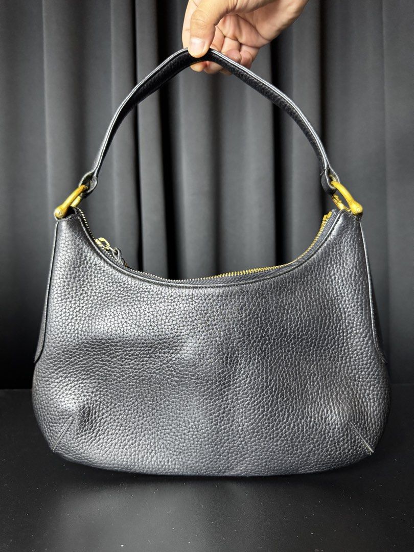 MCM Black Hobo Bag (Category: Luxury Bags & Wallets) located in Calamba. Submitted by maddy.cube (Listing ID 1436046521, Image 2). Description: - Black MCM hobo bag - Gold-tone hardware - Zip closure - Single shoulder strap - Interior zip pocket - MCM brand label - Textured leather finish - Gold MCM logo plate.
