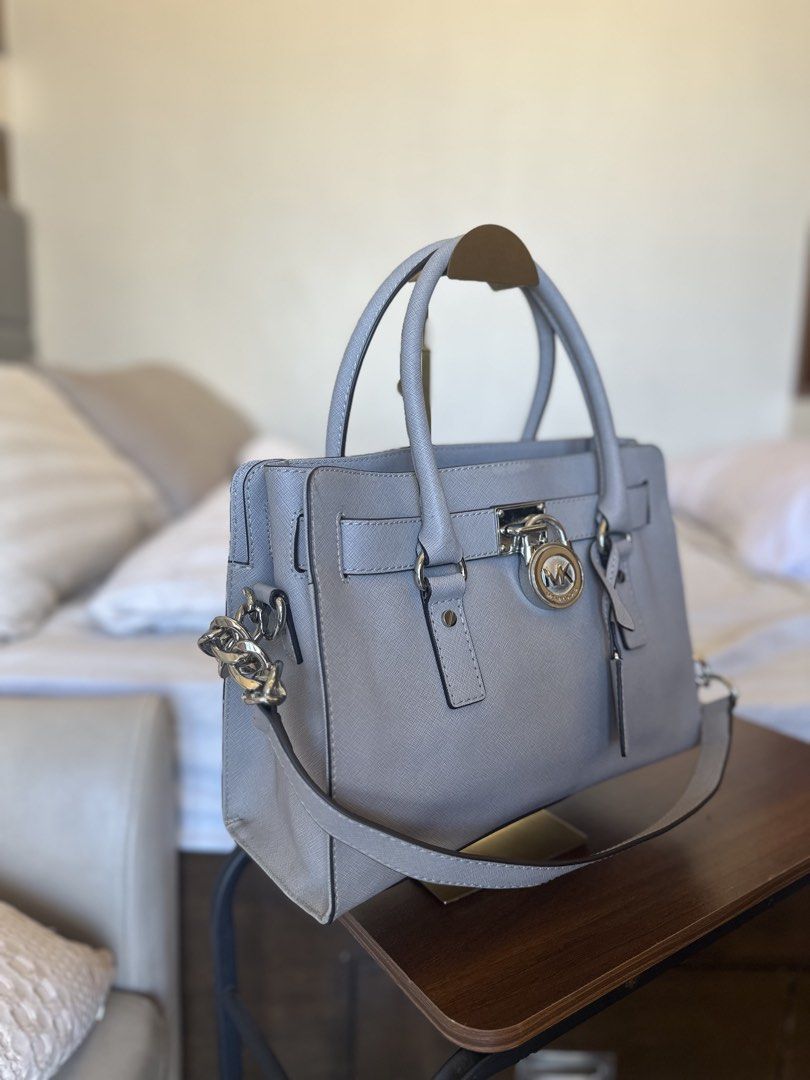 Michael Kors Hamilton Satchel Bag (Category: Luxury Bags & Wallets) located in Manila. Submitted by margaux12345678 (Listing ID 1436007042, Image 2). Description: Authentic Michael Kors Hamilton Bag ✨ Crafted in Saffiano leather Beautiful dusty blue color Comes with lock & keys 🔐 Condition: Excellent • Normal signs of use • No major flaws • Clean inside & out 💰 Only 2,999 🩵 AUTHENTIC MONEY BACK GUARANTEED.