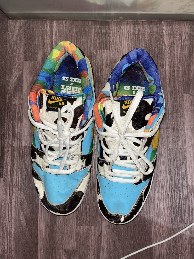 Nike SB Dunk Low x Ben & Jerry's Chunky Dunky (Category: Sneakers) located in Carmen. Submitted by by_your_stuff (Listing ID 1436057127, Image 1). Description: - Nike SB Dunk Low 'Chunky Dunky' collaboration with Ben & Jerry's. - Unique design with cowhide-like patterns. - Blue sky overlays. - Yellow swooshes. - Colorful tongue design. - Nike logo on the heel. - Green sole. - Nike SB Chunky Dunky logo on the insole..
