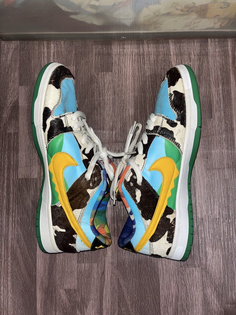 Nike SB Dunk Low x Ben & Jerry's Chunky Dunky (Category: Sneakers) located in Carmen. Submitted by by_your_stuff (Listing ID 1436057127, Image 3). Description: - Nike SB Dunk Low 'Chunky Dunky' collaboration with Ben & Jerry's. - Unique design with cowhide-like patterns. - Blue sky overlays. - Yellow swooshes. - Colorful tongue design. - Nike logo on the heel. - Green sole. - Nike SB Chunky Dunky logo on the insole..