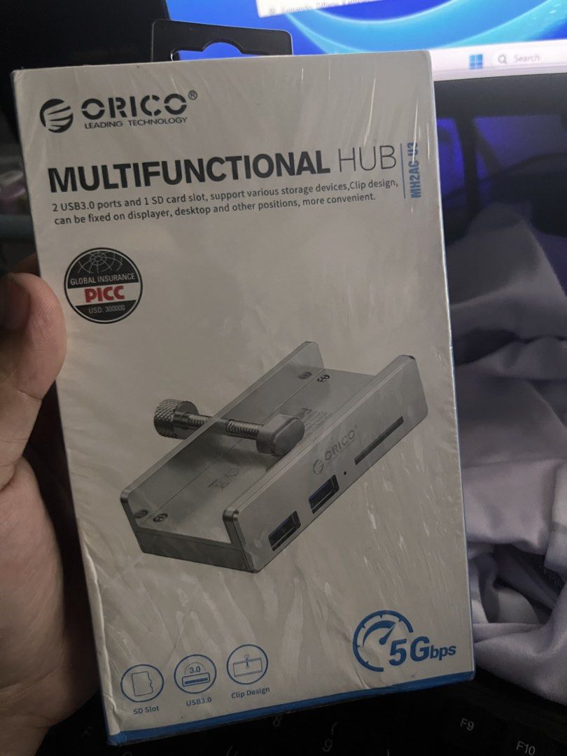 ORICO Multifunctional Hub MH2AC-U3 (Category: Cables & Adaptors) located in Cavite. Submitted by tifanny.goods (Listing ID 1436012232, Image 1). Description: - ORICO Multifunctional Hub with 2 USB 3.0 ports and 1 SD card slot. - Clip design for easy placement. - Supports various storage devices. - 5Gbps transfer rate. - Includes Micro-B port. - Compatible with Windows, Mac OS, and Linux..