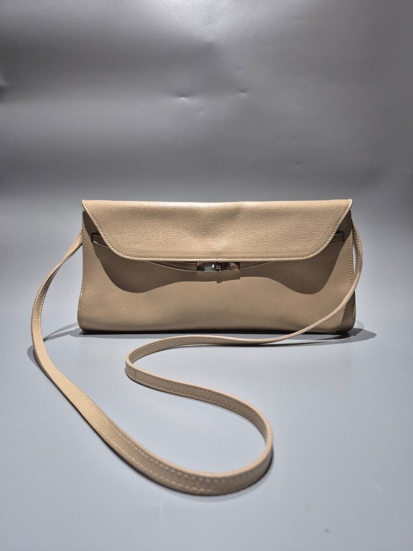 Preloved Furla Clutch Sling Bag (Category: Clutches) located in Tarlac. Submitted by mygarangesale (Listing ID 1436083148, Image 1). Description: Condition: Leather in good condition, with barely noticeable small spot stains fr the outside, meron din sya stain sa loob as you can see sa photo. detachable leather sling size: 30cm width 16cm ht, 45cm sling ht fr shoulder. Design: A sleek, rectangular silhouette with a foldover flap. Material: Graine