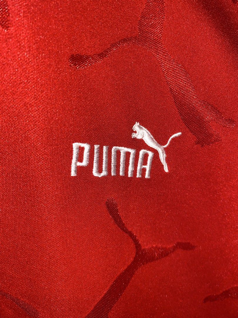Puma Red Football Jersey (Category: Activewear) located in San Pedro. Submitted by billfinds (Listing ID 1436036565, Image 2). Description: - Authentic Puma Football jersey - Color: Red - Size: Large - White collar and sleeve accents - Embroidered Puma logo - Unique Puma logo pattern on front.