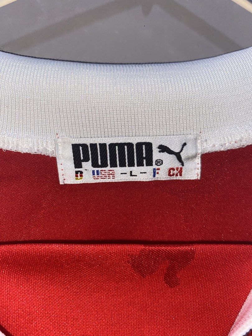 Puma Red Football Jersey (Category: Activewear) located in San Pedro. Submitted by billfinds (Listing ID 1436036565, Image 3). Description: - Authentic Puma Football jersey - Color: Red - Size: Large - White collar and sleeve accents - Embroidered Puma logo - Unique Puma logo pattern on front.