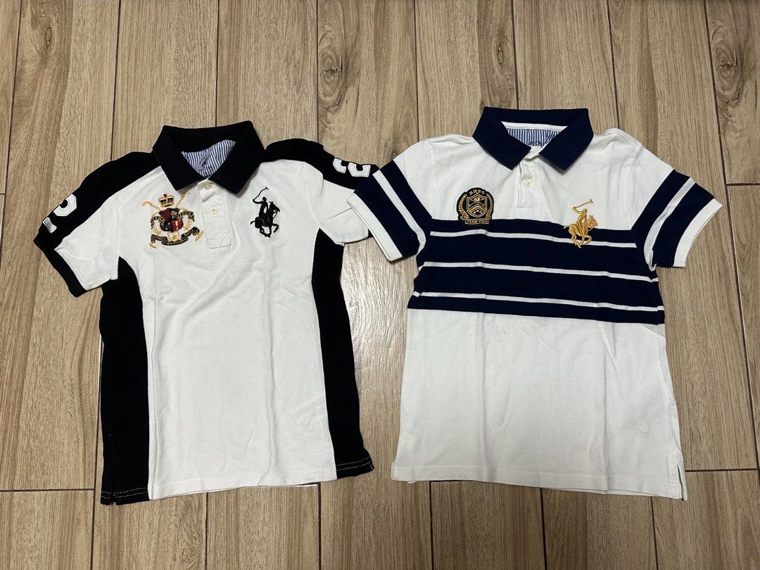 Ralph Lauren Polo Shirts (Category: Tshirts & Polo Shirts ) located in Manila. Submitted by sircee6 (Listing ID 1436042662, Image 1). Description: - 5-10 y/o as pack Two Ralph Lauren polo shirts. One is white with black accents and features a crest and a rider logo. The other is white with navy blue stripes and a crest and rider logo. Both shirts have short sleeves and a collared neckline..