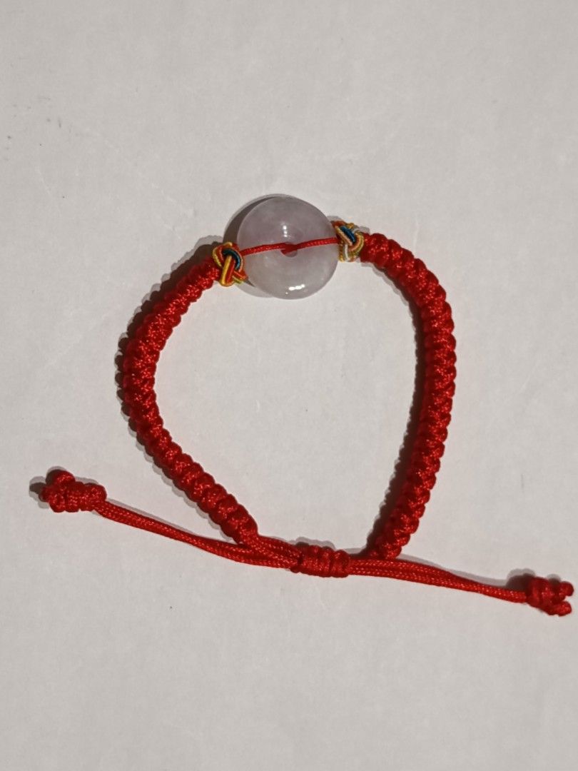Red String Donut Jade Bracelet (Category: Bracelets) located in Famy. Submitted by potato.label (Listing ID 1436001714, Image 3). Description: - Red string bracelet - Features a donut jade stone - Jade stone has a light purple hue - Adjustable sliding knot closure - Donut in Chinese culture symbolizes eternal protection - Suitable for daily wear.
