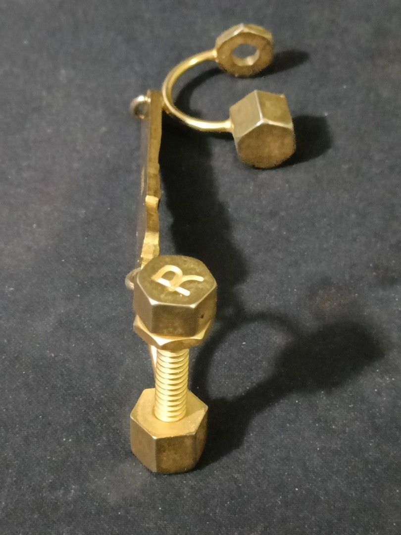 Roberta di Camerino Vintage Key Holder (Category: Purses & Pouches) located in Manila. Submitted by japoy22 (Listing ID 1436090139, Image 3). Description: Roberta di Camerino Vintage Key Holder P 1,800 Brand: Roberta di Camerino (Authentic hallmark visible on reverse). Motif: Features the iconic "belt and buckle" enamel work in signature navy blue, sandwiched between literal nut-and-bolt hardware. Material: Gold-toned base metal with high-quality