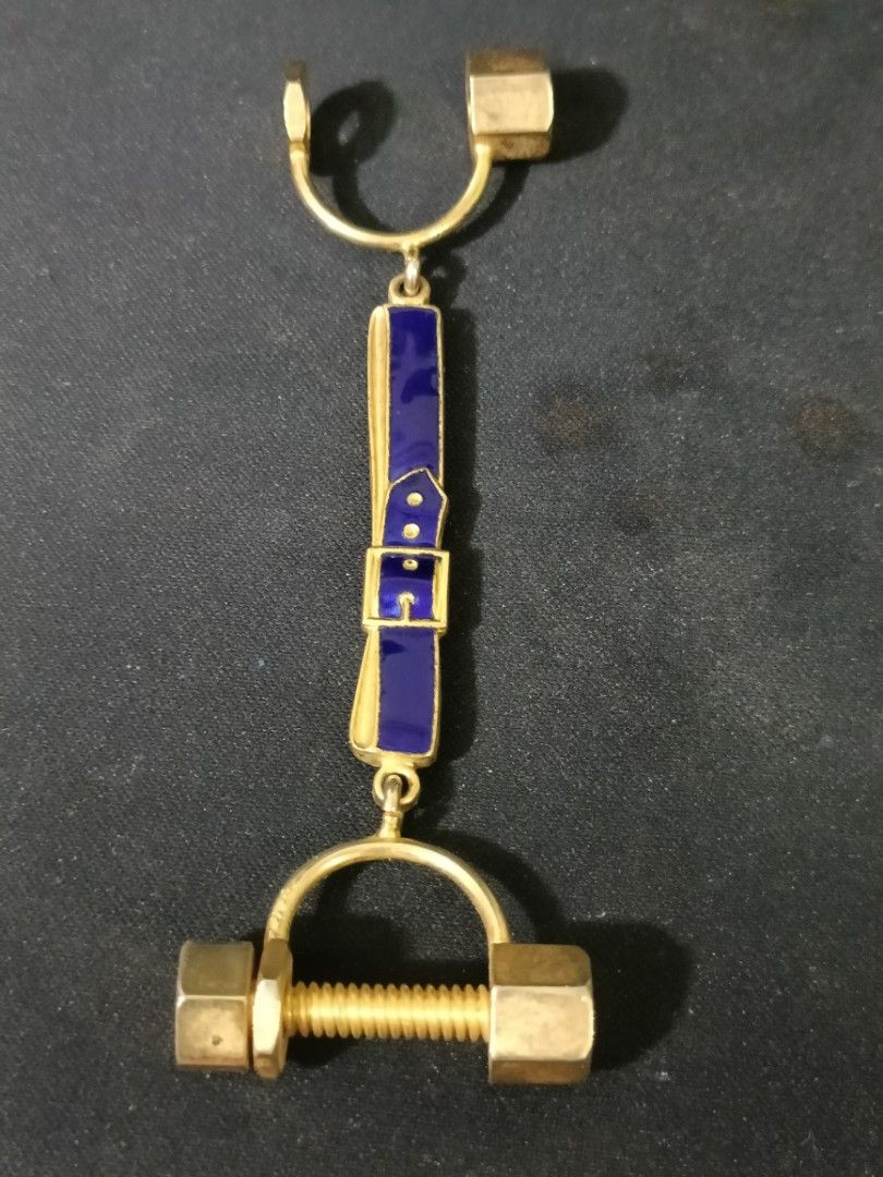 Roberta di Camerino Vintage Key Holder (Category: Purses & Pouches) located in Manila. Submitted by japoy22 (Listing ID 1436090139, Image 2). Description: Roberta di Camerino Vintage Key Holder P 1,800 Brand: Roberta di Camerino (Authentic hallmark visible on reverse). Motif: Features the iconic "belt and buckle" enamel work in signature navy blue, sandwiched between literal nut-and-bolt hardware. Material: Gold-toned base metal with high-quality