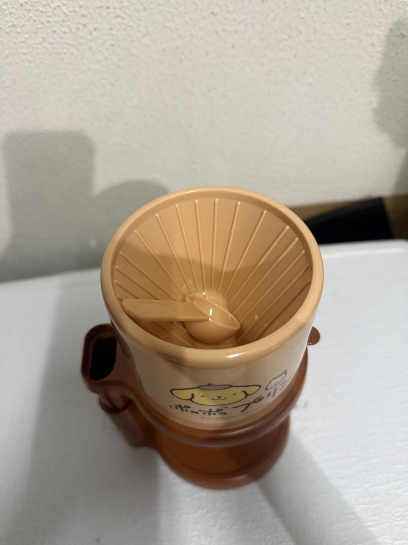 Sanrio PomPomPurin Coffee Maker dripper (Category: Coffee Machines & Makers) located in Marikina City. Submitted by ellapam (Listing ID 1436015678, Image 2). Description: - Sanrio Pom Pom Purin coffee maker - Adorable brown and beige color scheme - Includes filter and scoop - Adjustable stand - Ideal for brewing coffee.