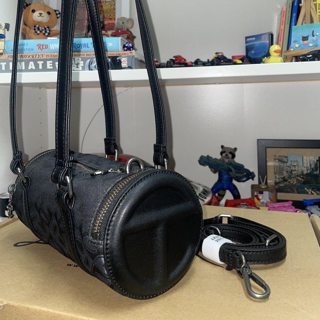 Small Jacquard Telfar Duffle (Category: Luxury Bags & Wallets) located in Cavite. Submitted by ajdelrosario (Listing ID 1435988648, Image 2). Description: - Black Telfar cylinder bag - Detachable strap included - Zip closure - Telfar logo on front and zipper pull - Patterned exterior - Telfar label inside Bought directly from Telfar’s official website 100% Authentic Vegan Leather Used 5x only No damage Long strap never been used Complete with dus