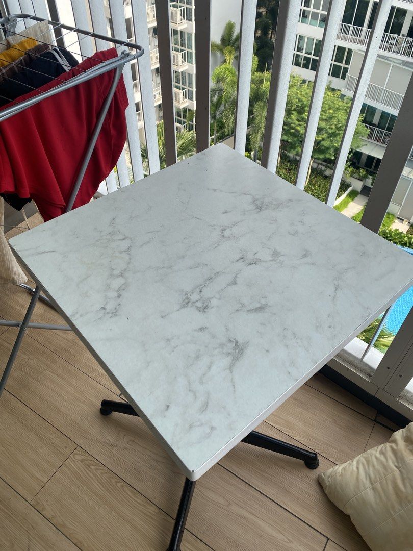 Square table (Category: Tables & Sets) located in Singapore. Submitted by plasticfuentes (Listing ID 1435921794, Image 2). Description: - Square table with marble-look top - Black metal legs - Perfect for small spaces or side table - Sturdy and functional - self pick up .
