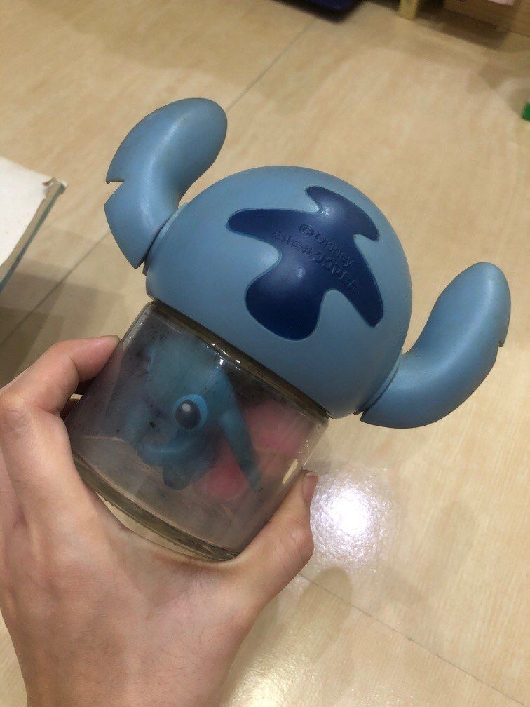 Stitch Coin Bank (Category: Fan Merchandise) located in Marilao. Submitted by donna.jimenez (Listing ID 1435934060, Image 2). Description: Stitch Coin Bank (Lilo and Stitch) Material: Stitch Head is made of plastic while the body is made of glass. I got some other small collectibles inside that are for FREE. Reason for sale: Not into it anymore used to collect but lose interest. Need funds. Flaws: Mark of tape on the top hole of the head where yo