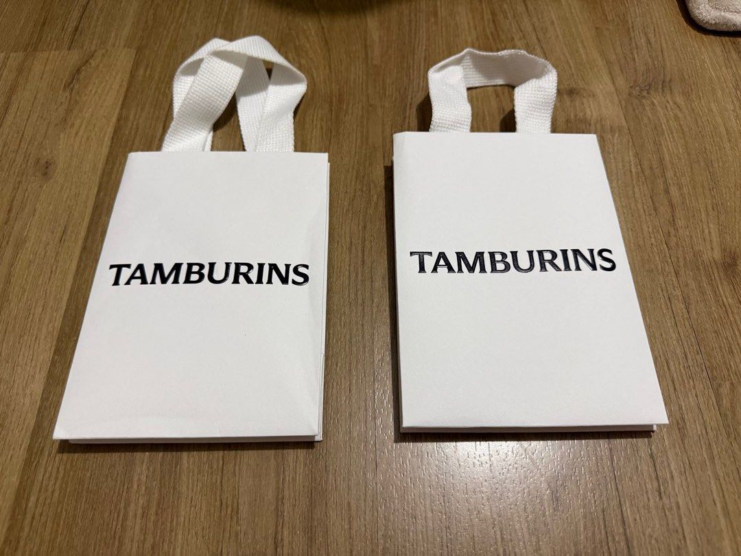 Tamburins Gift Bag (Category: Craft Supplies & Tools) located in Valenzuela. Submitted by minami34 (Listing ID 1436029966, Image 1). Description: - Two Tamburins gift bags included - Features Tamburins Embossed logo - White handles - Includes two black cards - Ideal for gifts or small items - Unused condition Dimensions: (L- 16.5cm x W- 11.6cm x D - 6cm) Reason for selling: Declutter Note: Shipping Fee (SF) still not included. Mode of Payment: Ba