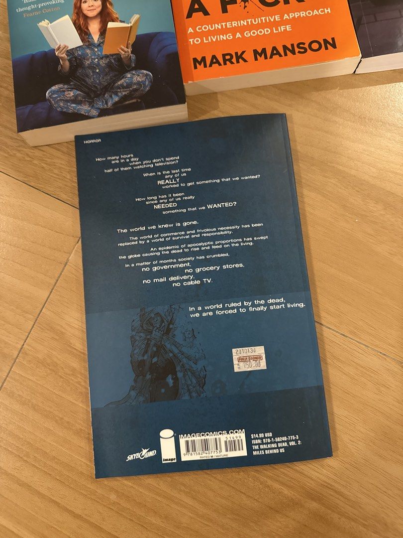 The Walking Dead Comic Book volume 2 (Category: Comics & Manga) located in Paranaque City. Submitted by charshabao (Listing ID 1435933283, Image 3). Description: - The Walking Dead: Volume 2 - Miles Behind Us - Published by Image Comics - In English - Features a dark blue back cover with text about the world ruled by the dead..