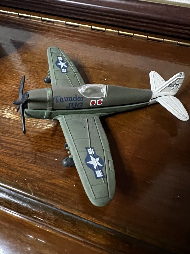 Thunder Jug Toy Airplane (Category: Toys & Games) located in Paranaque City. Submitted by jtong00 (Listing ID 1436025540, Image 1). Description: - Olive green toy airplane - White stars and "Thunder Jug" text - White tail with "42921" - Classic collectible item - Great for display.