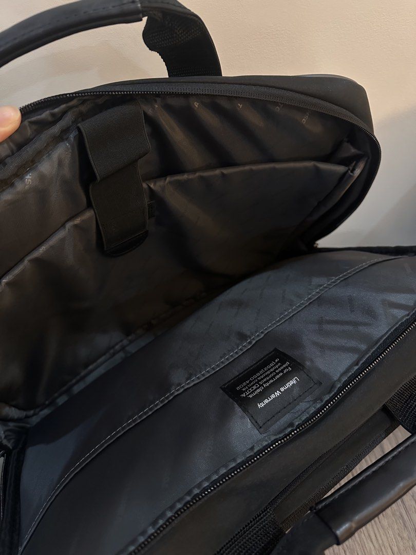 Toshiba Laptop Bag with Shoulder Strap (Category: Laptop Bags & Sleeves) located in Caloocan City. Submitted by kween.of.decluttering (Listing ID 1436078582, Image 3). Description: - Black Toshiba laptop bag - Features a handle and detachable shoulder strap - Multiple internal compartments - Includes pockets for pens and accessories - Toshiba logo on front and handle strap - Comes with a lifetime warranty.
