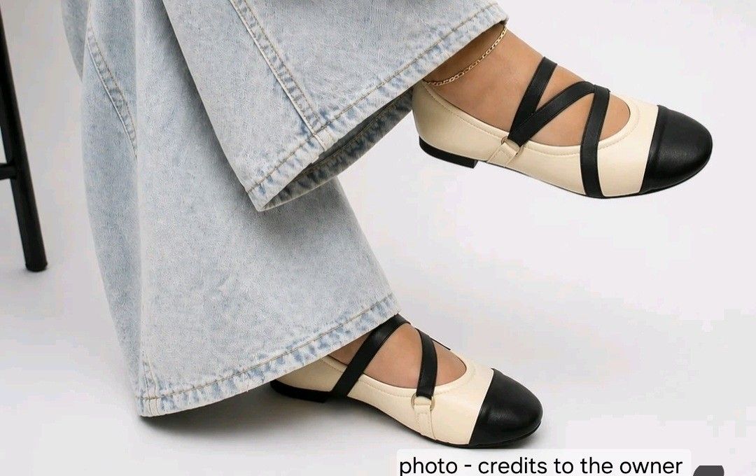 Two-Tone Ballet Flats (Category: Flats & Sandals) located in Makati City. Submitted by grande.taille.by.ab (Listing ID 1436092950, Image 1). Description: Stylish ballet flats featuring a two-tone design with a cream body and black toe cap and straps. The straps cross over the foot for a secure fit. These flats are perfect for everyday wear, offering both comfort and a chic look. They are a versatile addition to any wardrobe..