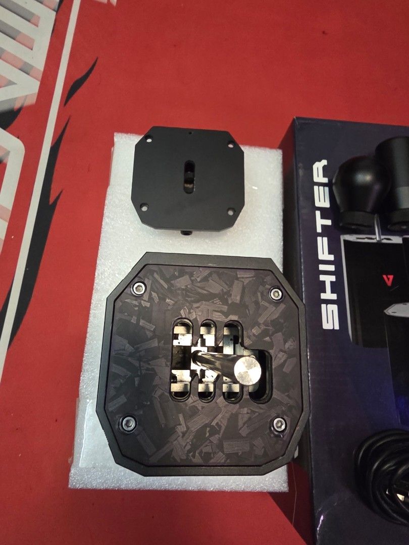 VNM Shifter V1 Basic Bundle (Category: Controllers) located in Petaling Jaya. Submitted by imcarbon (Listing ID 1435954580, Image 2). Description: - VNM Shifter V1 Basic Bundle - Includes shifter unit, mounting plate, and accessories - Features: - Customizable driving style - Quick and easy setup - Comes with a USB cable - Box includes product features and setup instructions.