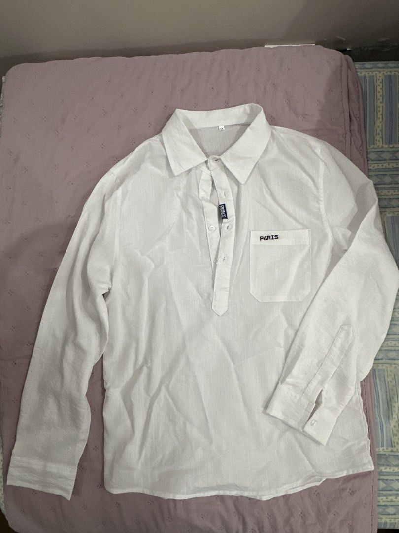 White Long Sleeve Shirt with Pocket (Category: Tshirts & Polo Shirts ) located in Manila. Submitted by sunschra (Listing ID 1436043191, Image 1). Description: - White long sleeve shirt - Features a chest pocket with "PARIS" printed on it - Collared neckline - Button details - Relaxed fit - Made of lightweight fabric.