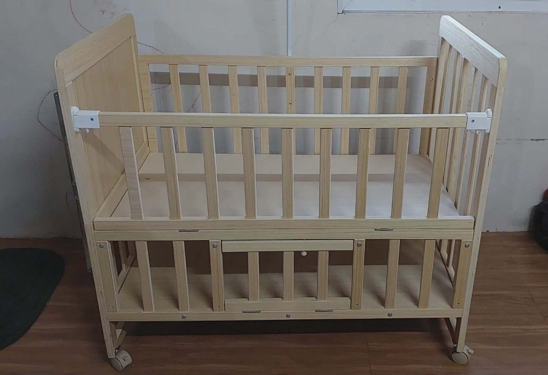 Wooden Baby Crib with Storage (Category: Cots & Cribs) located in Tarlac. Submitted by ladymama11 (Listing ID 1436071164, Image 3). Description: - Wooden baby crib with convertible design: crib, extended bed, and cradle modes. - Includes free gifts: bed-rest, pillow, mattress, bed surround cloth, and mosquito net. - Features a convenient storage drawer. - Made of light-colored wood. - Simple and classic design. rfs. already switch to playpen boug