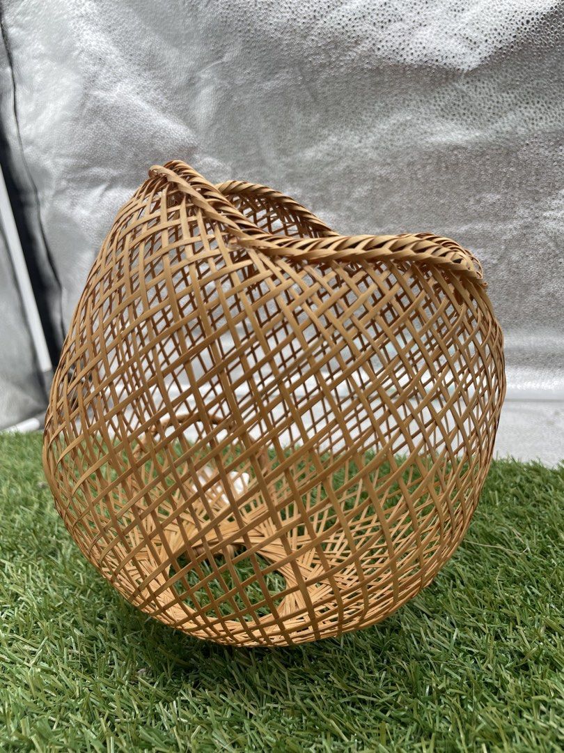 Woven Bamboo Basket (Category: Storage Boxes & Baskets) located in Quezon City. Submitted by eilgaraje (Listing ID 1435932915, Image 1). Description: - Handwoven bamboo basket - Unique open design - Natural brown color - Sturdy and well-crafted - Perfect for storage or decoration - Approximately 20cm in length.