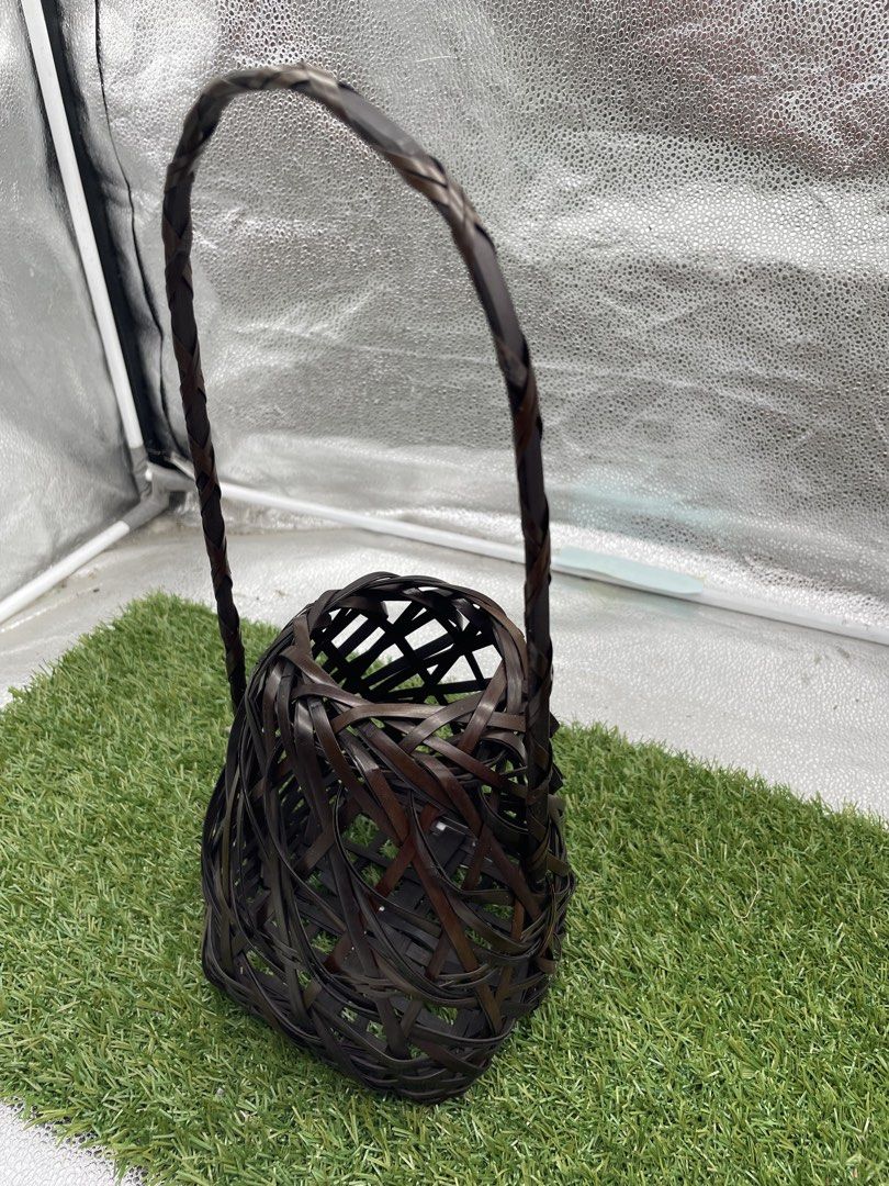 Woven Bamboo Basket with Handle (Category: Storage Boxes & Baskets) located in Quezon City. Submitted by eilgaraje (Listing ID 1435934640, Image 3). Description: - Handwoven bamboo basket - Features a dark brown color - Intricate, open design - Includes a handle for easy carrying - Dimensions: Approximately 10cm (width) x 20cm (height) - Perfect for decorative use or unique storage.