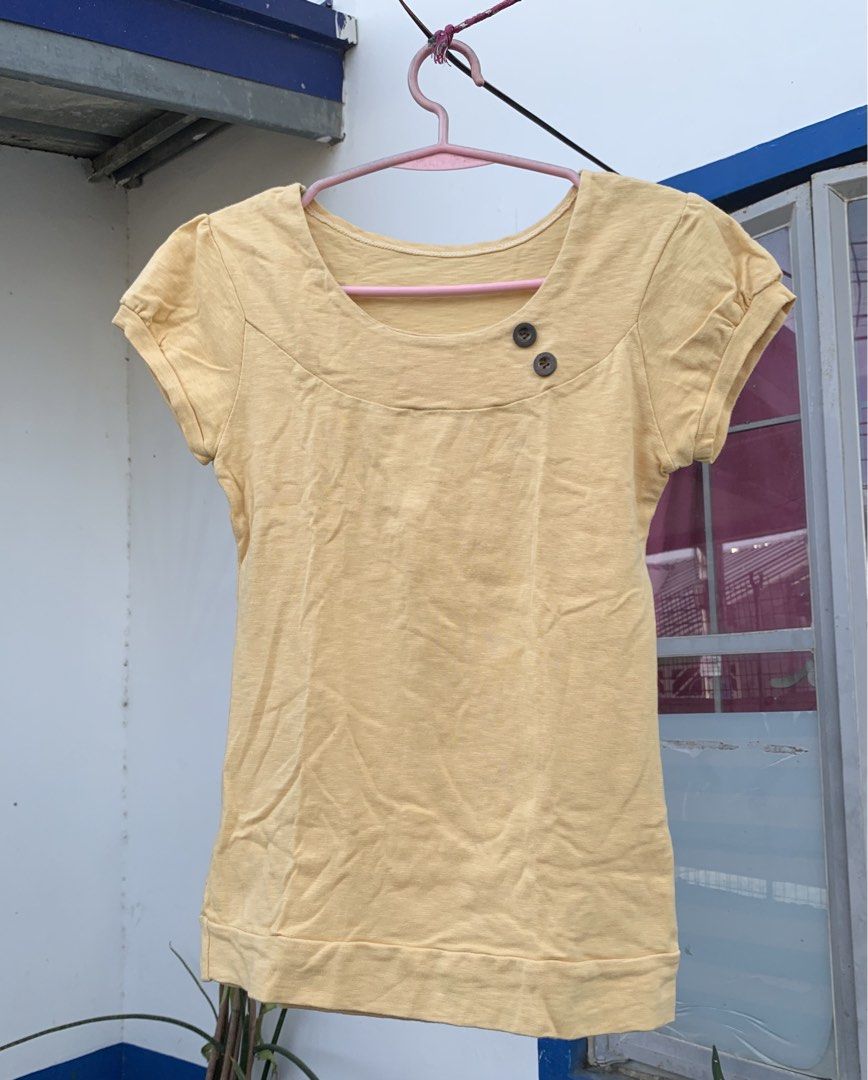 Yellow Short Sleeve Top with Buttons (Category: Shirts) located in Cavite. Submitted by jetsyfinds (Listing ID 1436058346, Image 1). Description: - Yellow short-sleeved top - Scoop neck design - Features two buttons - Rolled-up sleeves - Made of soft fabric - Easy to dress up or down.