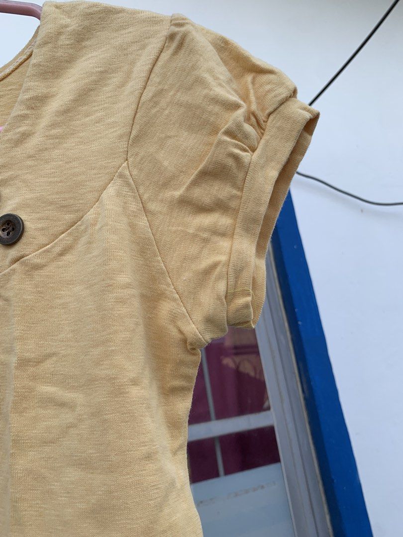 Yellow Short Sleeve Top with Buttons (Category: Shirts) located in Cavite. Submitted by jetsyfinds (Listing ID 1436058346, Image 3). Description: - Yellow short-sleeved top - Scoop neck design - Features two buttons - Rolled-up sleeves - Made of soft fabric - Easy to dress up or down.