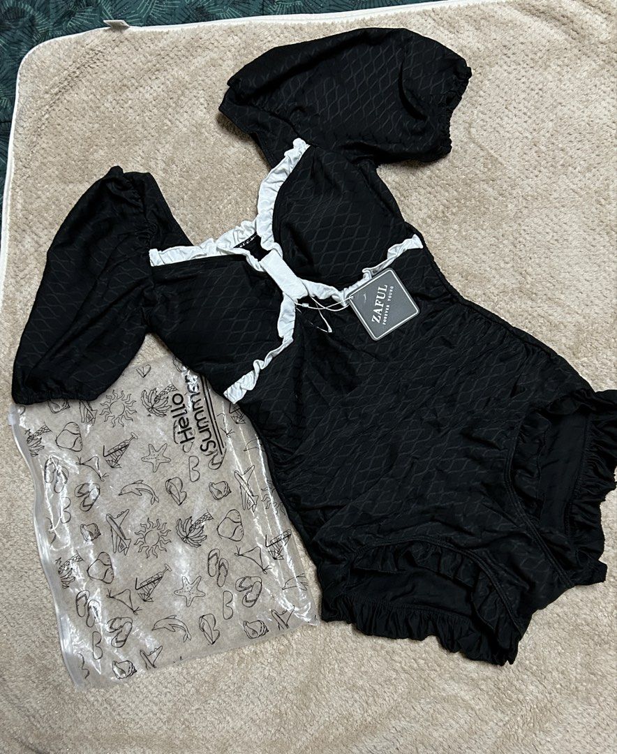 Zaful Black Ruffle One pieceSwimsuit (Category: Bikinis & Swimsuits) located in Caloocan City. Submitted by lilzariyahhhh (Listing ID 1436005322, Image 1). Description: - Zaful swimsuit - Black textured fabric - White ruffle trim - Short puff sleeves - Square neckline - New with tags - Comes with og pouch - fits xs-s frame - Perfect for summer!.