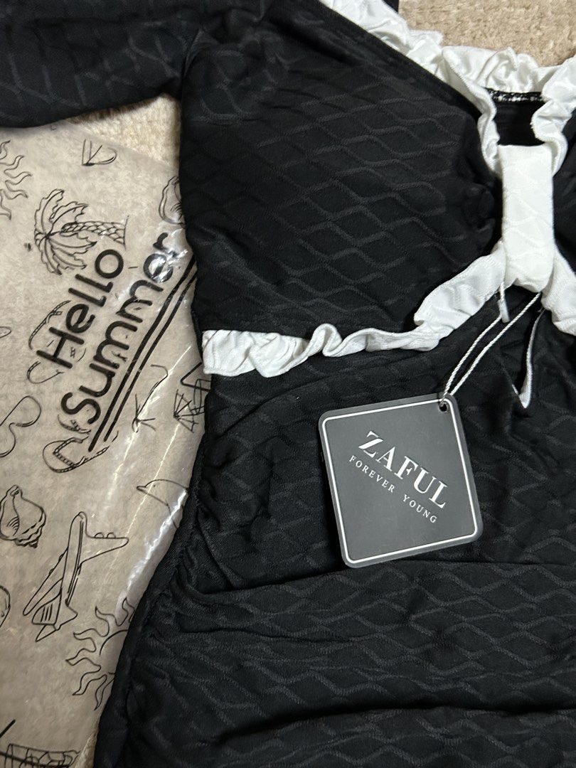 Zaful Black Ruffle One pieceSwimsuit (Category: Bikinis & Swimsuits) located in Caloocan City. Submitted by lilzariyahhhh (Listing ID 1436005322, Image 2). Description: - Zaful swimsuit - Black textured fabric - White ruffle trim - Short puff sleeves - Square neckline - New with tags - Comes with og pouch - fits xs-s frame - Perfect for summer!.