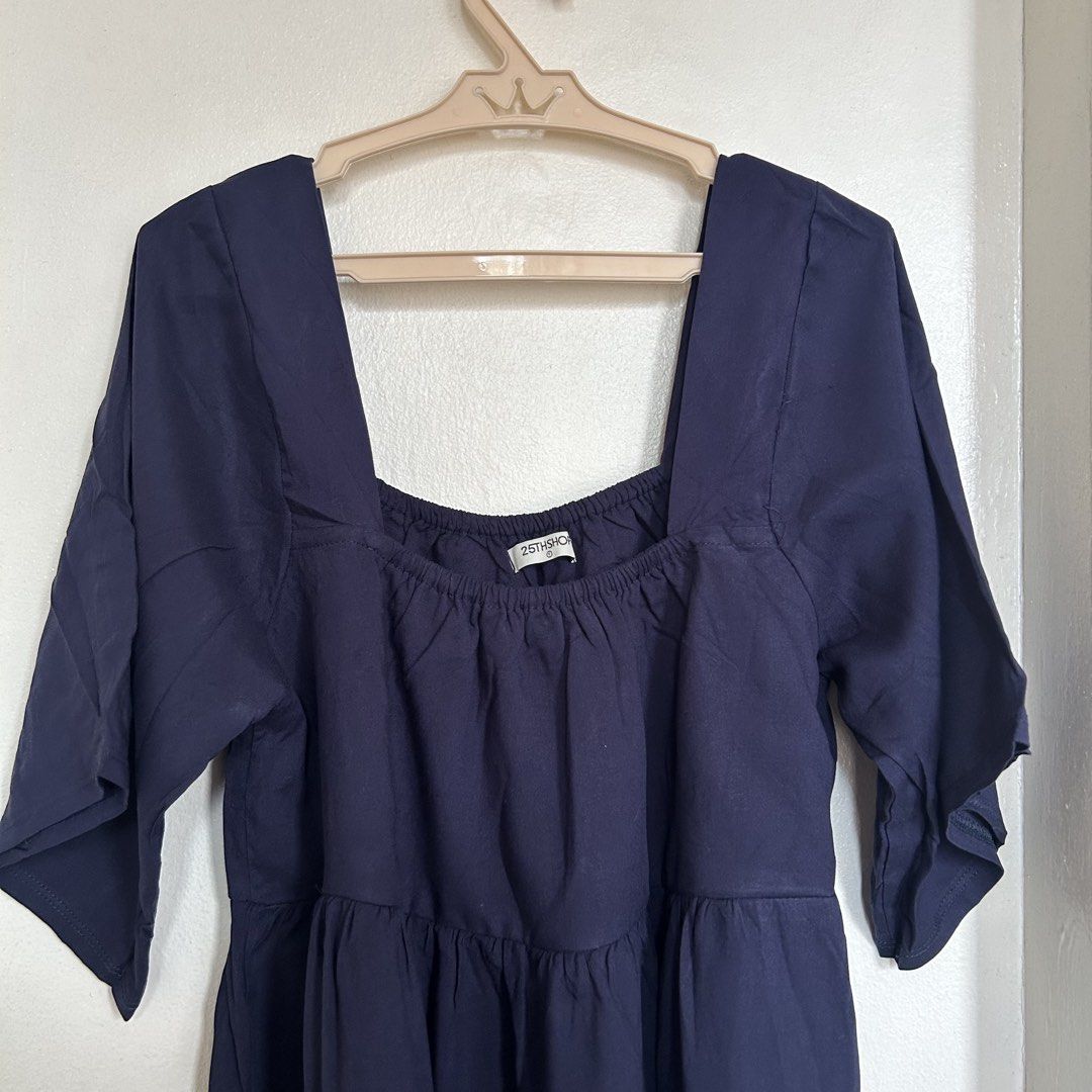 25THSHOP Navy Blue Square Neck Dress (Category: Dresses) located in Caloocan City. Submitted by mariasonya (Listing ID 1436102772, Image 1). Description: - Navy blue dress from 25THSHOP - Square neckline - Three-quarter sleeves - Tiered design - Ruffled hem - Lightweight fabric - Ideal for casual wear.