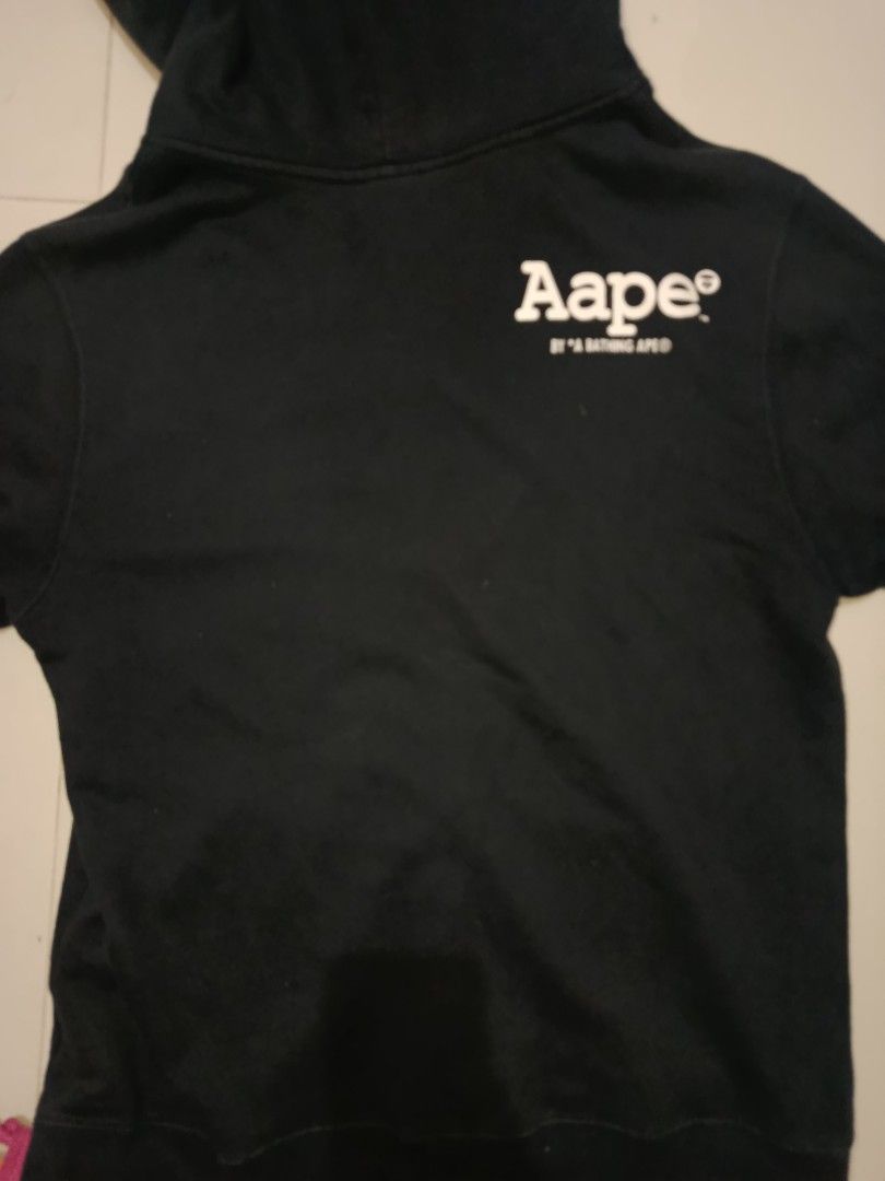 Aape by A Bathing Ape Zip-Up Hoodie (Category: Coats, Jackets and Outerwear) located in Manila. Submitted by dredvillag58696 (Listing ID 1436168733, Image 3). Description: DIMES: W20 L27 ISSUE : CUT NECKTAG COLOR RATE 9/10 - Aape by A Bathing Ape black zip-up hoodie. - Features a front logo patch. - Small Aape logo on the pocket. - Aape logo printed on the back. - Aape logo zipper pull. - Hood with drawstrings. - Two front pockets..