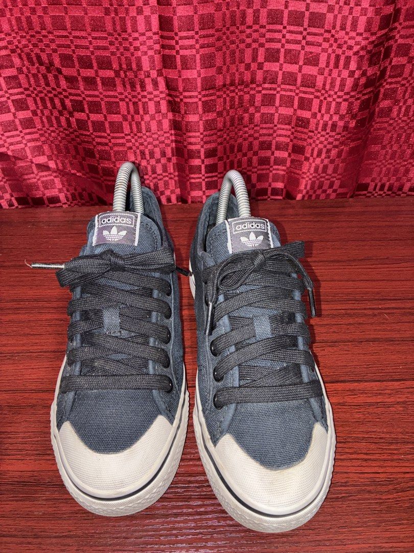 Adidas Nizza Low Top Sneakers (Category: Sneakers) located in Placer. Submitted by talaalond61563 (Listing ID 1436205798, Image 1). Description: - Adidas Nizza low-top sneakers - Dark blue color - Adidas logo on tongue, side, and heel - White sole - Black laces - Shows some wear on soles - Adidas branding on insole.