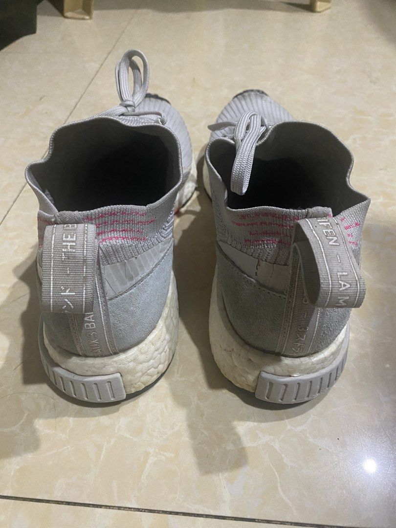 Adidas NMD_CS1 Primeknit Grey (Category: Sneakers) located in Manila. Submitted by decluttering_007 (Listing ID 1436101652, Image 3). Description: Negotiable. Intact, ready to use. Signs of use and reglue/restore. No seps, intact. - Adidas NMD_CS1 Primeknit sneakers - Color: Grey - Features a sock-like upper with laces - Boost midsole with colored accents - Japanese text on heel tab - Signs of wear on soles and uppers.