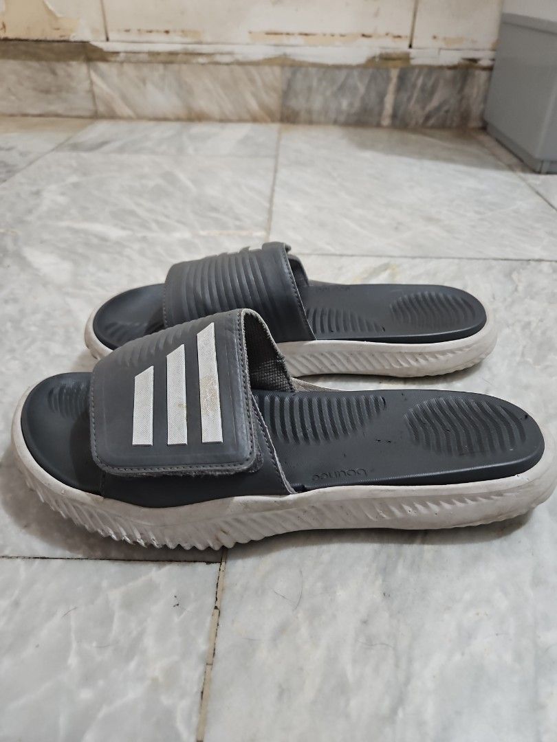 Adidas Slides with Bounce Technology (Category: Slippers & Slides) located in Pasig City. Submitted by strengthlab (Listing ID 1436153751, Image 3). Description: size 1w. sole needs cleaning only. overall great condition - Adidas slides with the classic three stripes. - Dark grey strap and footbed. - White sole. - Features Adidas "bounce" technology for enhanced comfort. - Ideal for casual wear and post-workout recovery..
