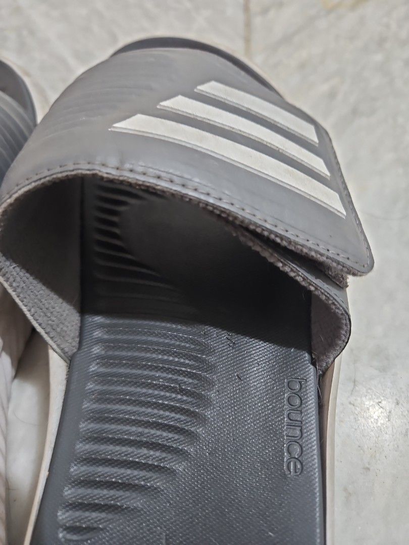 Adidas Slides with Bounce Technology (Category: Slippers & Slides) located in Pasig City. Submitted by strengthlab (Listing ID 1436153751, Image 2). Description: size 1w. sole needs cleaning only. overall great condition - Adidas slides with the classic three stripes. - Dark grey strap and footbed. - White sole. - Features Adidas "bounce" technology for enhanced comfort. - Ideal for casual wear and post-workout recovery..