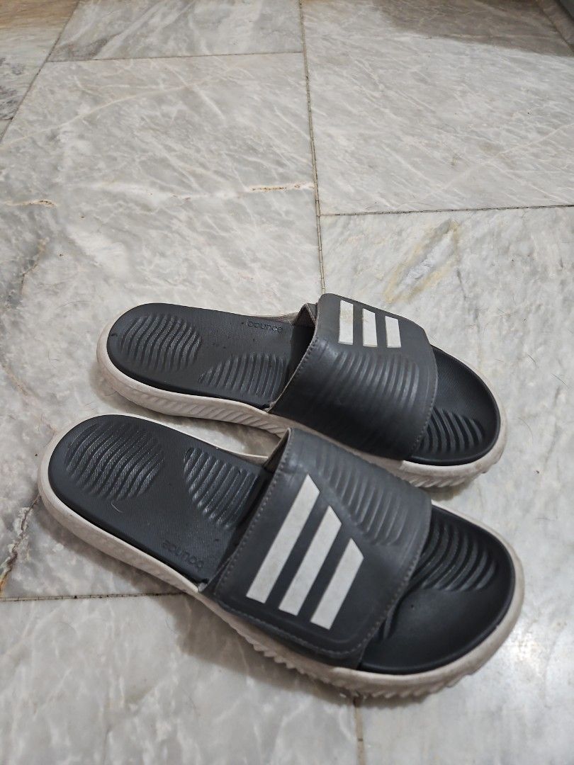 Adidas Slides with Bounce Technology (Category: Slippers & Slides) located in Pasig City. Submitted by strengthlab (Listing ID 1436153751, Image 1). Description: size 1w. sole needs cleaning only. overall great condition - Adidas slides with the classic three stripes. - Dark grey strap and footbed. - White sole. - Features Adidas "bounce" technology for enhanced comfort. - Ideal for casual wear and post-workout recovery..