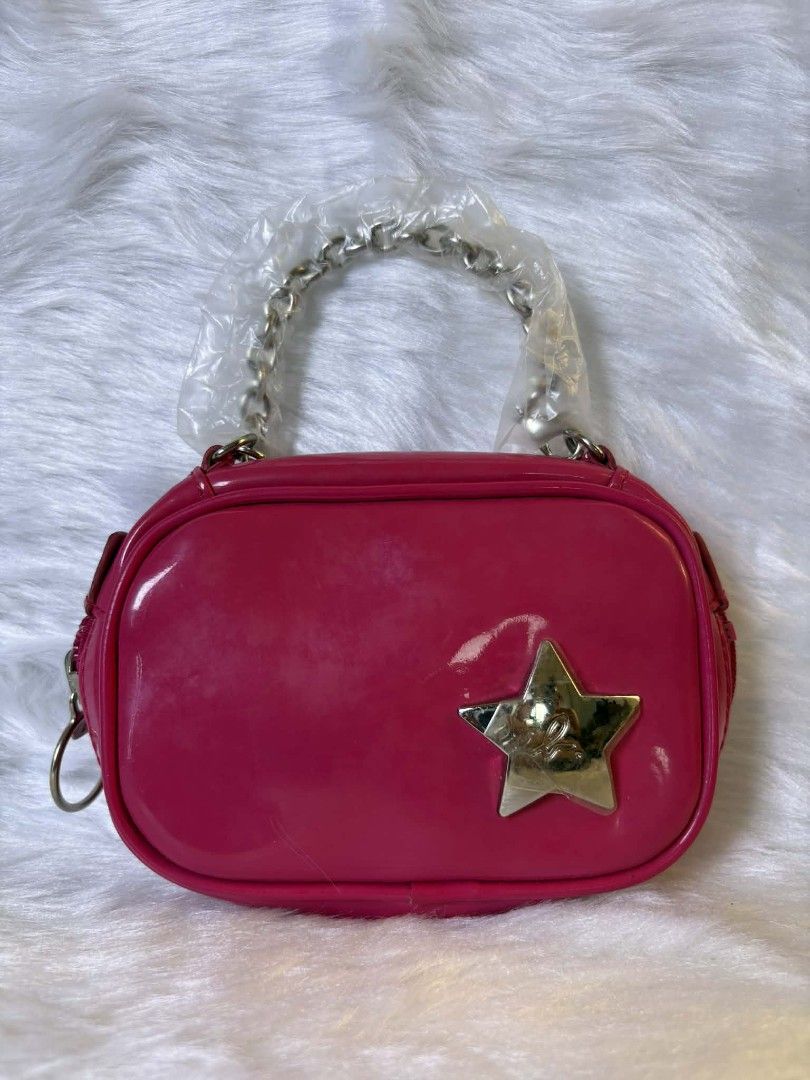 Agnes b chain purse (Category: Luxury Bags & Wallets) located in Manila. Submitted by andrea_1166 (Listing ID 1436209155, Image 1). Description: Pink handbag features a shiny finish and a silver star detail on the front. The bag is a vibrant pink color and has a compact, rectangular shape. It's a stylish accessory for any outfit..
